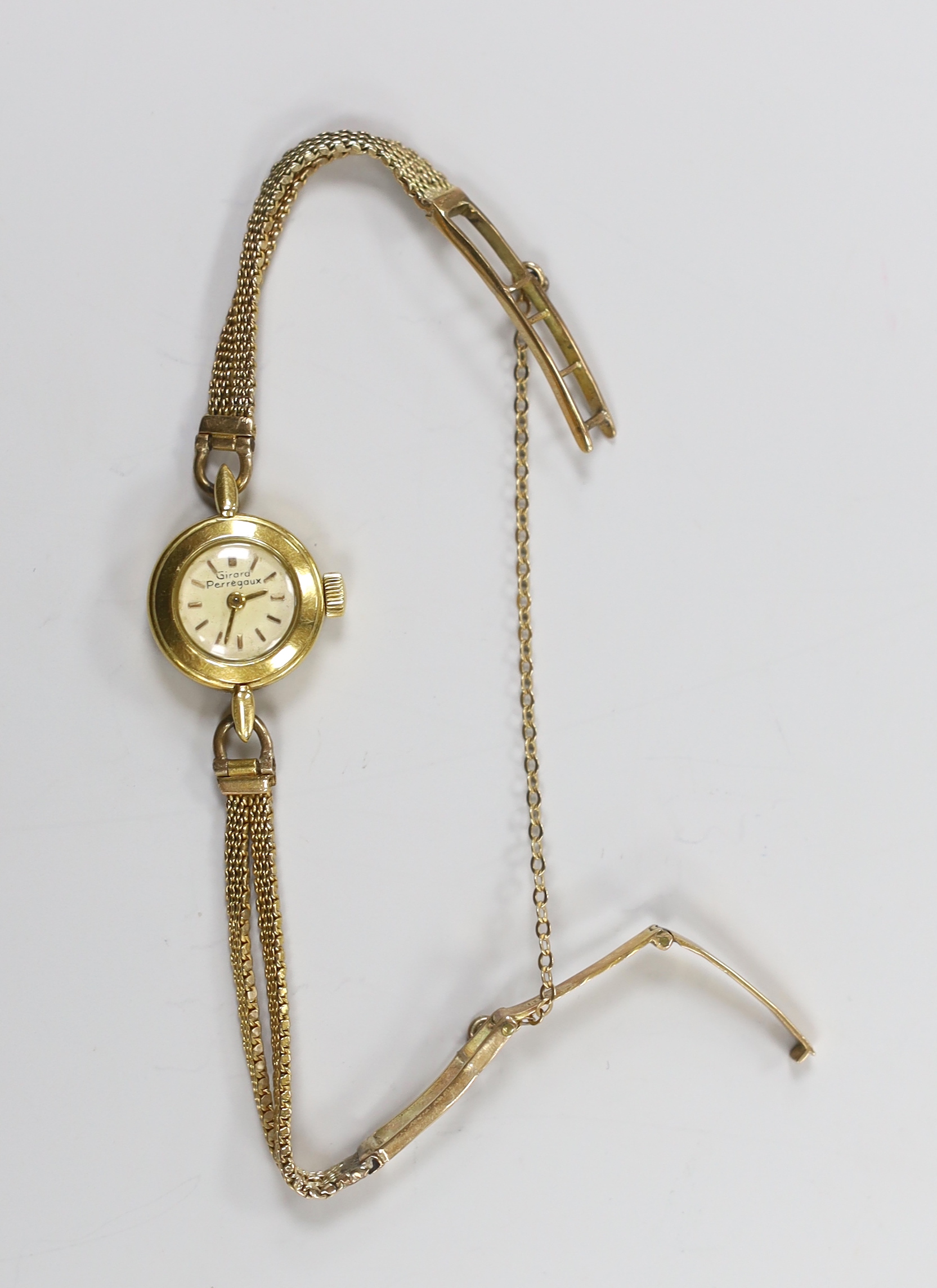 A lady's yellow metal Girard Perregaux manual wind wrist watch, on a 9ct twin strand bracelet, gross weight 12.6 grams, with Girard Perregaux box.